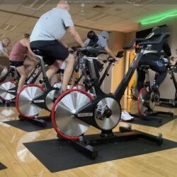 Instructor leading group cycling class